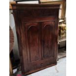 A Georgian mahogany corner cupboard with double arch doors and small drawer below