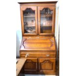 A cherrywood bureau bookcase with fall front, single drawer and double cupboard to base