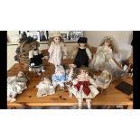 A collection of 10 modern china head dolls in Victorian dress