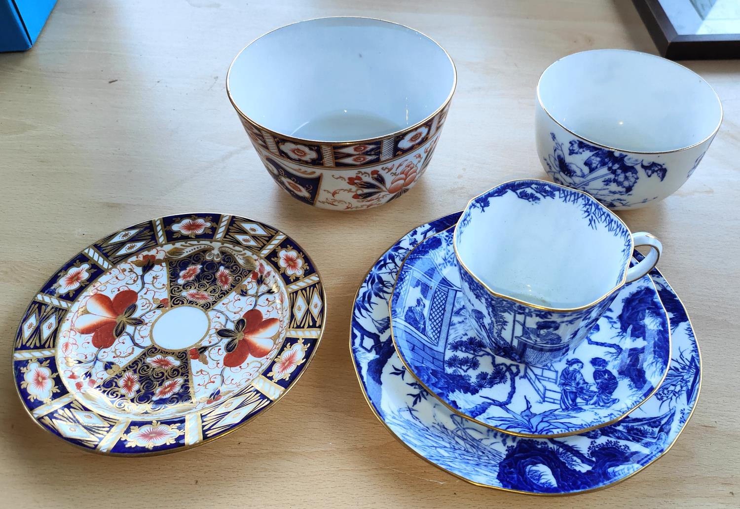A Royal Crown Derby blue and white trio set, two similar pieces