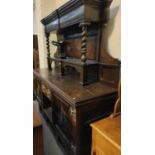 A 19th century Jacobean style large dresser with raised panel back, 2 carved end cupboards,