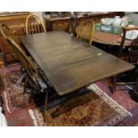 An Ercol modern refectory dining table with draw leaves, extending to 185cm, and 4 chairs with