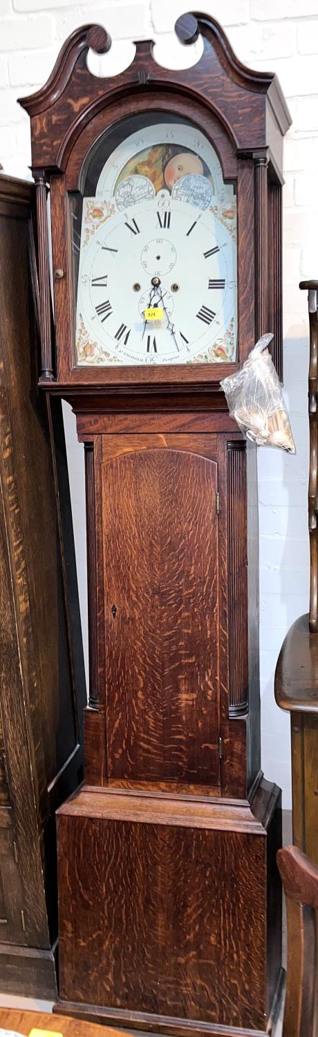 An early 19th century oak longcase clock with swan neck pediment and reeded side columns to the