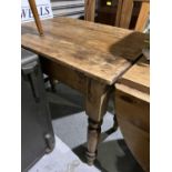 A Victorian stripped pine table with drawer and single drop leaf