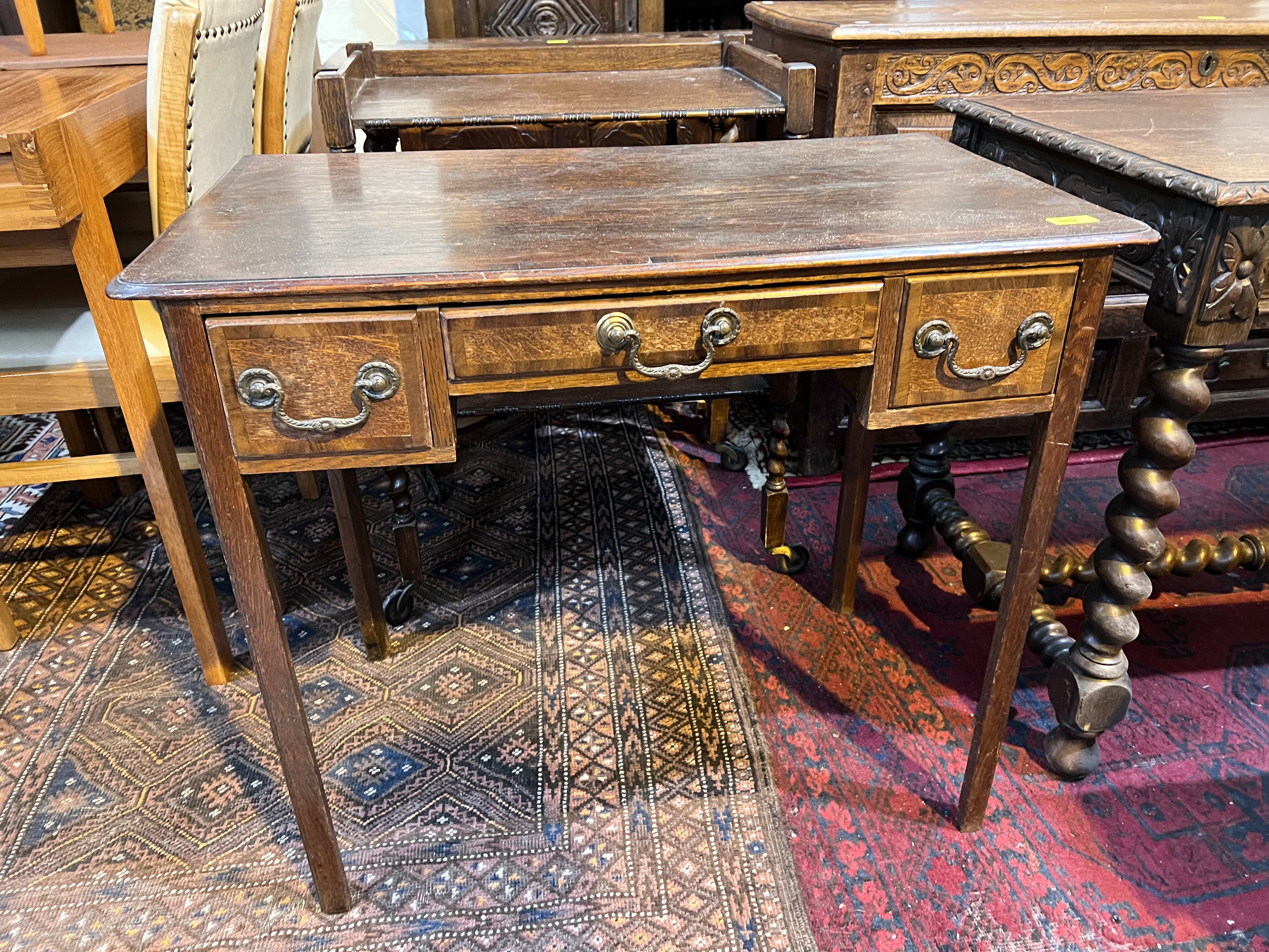 A Georgian cross banded oak lowboy with squared champhered legs, three drawers ht. 71cm x depth 32cm