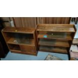 A 1950's light oak 3 height bookcase enclosed by sliding glass doors; a similar 2 height bookcase