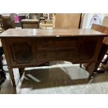 A continental walnut sideboard with a pair of cupboards flanking two drawers on square legs. 66'