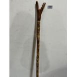 A burlwood thumbstick, the stripped hazel shaft decorated with pyrography of animal heads and carved