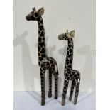 A pair of painted carved wood models of giraffes, the larger 31½' high
