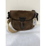 An antique canvas and leather cartridge bag. 9½' wide
