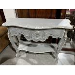 A French style distress decorated serpentine two-tier hall table. 48' wide