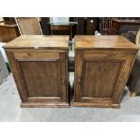 A pair of pine cupboards, each enclosed by a panel door. 23½'w x 33½'h