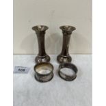 Two silver loaded bud vases, 4' high; and two silver napkin rings