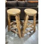 A pair of oak stools