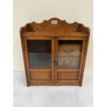 A late Victorian oak smoker's cabinet. 18' high