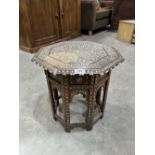 An Islamic foliate bone inlaid octagonal table on folding base. 16' diam