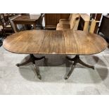 A good quality Regency style twin pedestal dining table, extending to 71½' long with original leaf