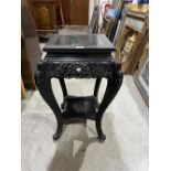 A Chinese ebonised pot stand. 28' high