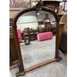An arched overmantle mirror. 50' high