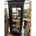 An eastern carved door frame, fitted as a bookcase with three glass shelves. 34'w x 74½'h. Purchased