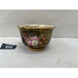 A Coalport cabinet cup, gilded and painted with a spray of summer flowers, probably by William Cook.