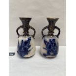 A pair of Doulton Burslem two handled vases, painted with blue foliage and gilded. 8' high