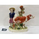 A 19th century Staffordshire cow and dairyman creamer. 8' long