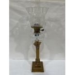 A Victorian brass corinthian base duplex oil lamp with clear glass fount and acid etched crimped