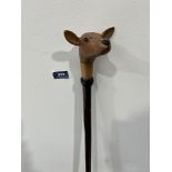 A hazel walking stick, the pommel hand carved as a fawn with glass eyes. 51' long