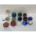 A collection of fourteen glass paperweights