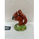 A 19th century Staffordshire model of a red squirrel eating a nut. 3½' high