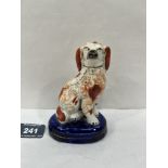 A 19th century Staffordshire spaniel painted in iron red on a blue base. 4½' high