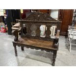 A Victorian carved oak hall bench. 42' wide