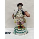 A 19th century porcelaneous figure of an actor, brightly painted in coloured enamels and gilded. 8½'