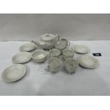 A lustre glazed shell moulded tea service of thirteen pieces. Teapot lid associated