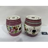 Two 19th century Staffordshire barrels, painted in enamels with summer flowers and bearing initials.