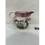 A 19th century Sunderland pink lustre jug, decorated with a ship to one side and a verse to the