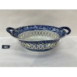 A 19th century reticulated two handled ovoid deep bowl, decorated in blue and white with bands of