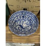 A pottery bowl painted with a peafowl and foliage on a lustrous glaze. 9' diam. Damage, repairs