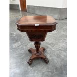 An early Victorian mahogany work table, the octagonal lid enclosing a fitted interior, raised on a