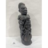 An African carved ebony wood sculpture, mother with attendant children entwined. 13' high