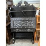 A Victorian carved oak writing bureau. 32' wide