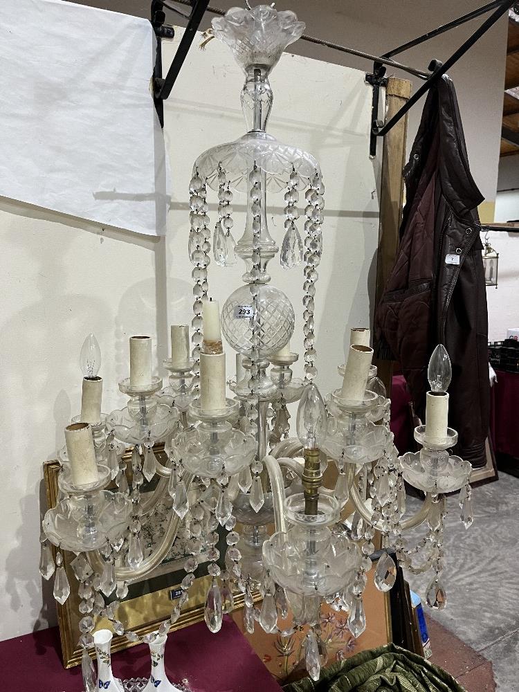 A French twelve light cut glass chandelier, the scrolled arms in two tiers, hung with swag and