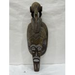 A carved wood and painted African tribal mask. 26' high