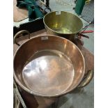 A copper preserving pan and another brass example