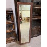 An oak framed wall mirror with bevelled plate