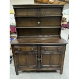 An Ercol oak dresser with raised rack, 48' wide