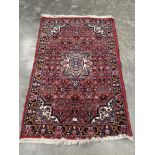 A red ground eastern rug. 63' x 41'