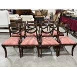A set of eight mahogany reeded frame dining chairs on sabre legs, the lot to include two carvers