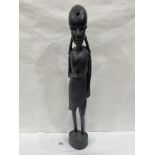 An African carved ebony sculpture of a woman. 25' high